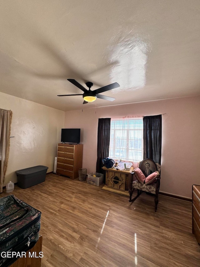 interior space featuring a textured ceiling, hardwood / wood-style flooring, and ceiling fan