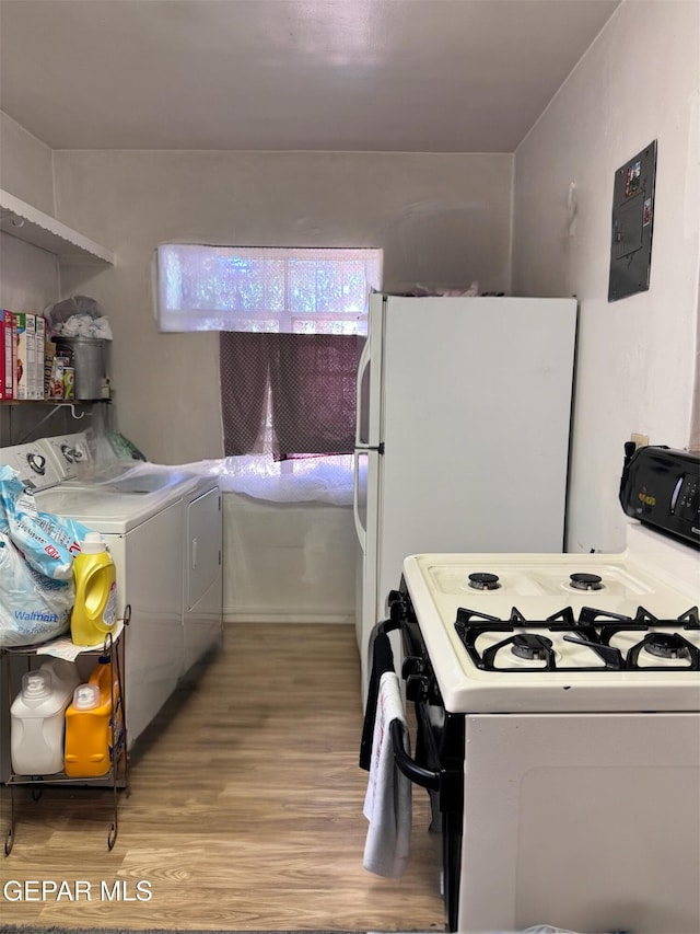 kitchen featuring light wood-type flooring and white appliances