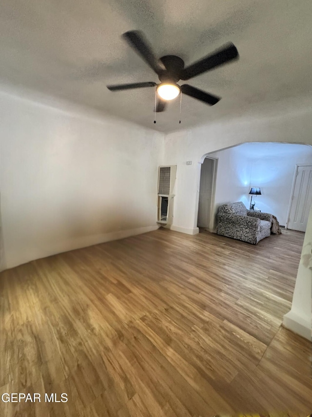 unfurnished bedroom with hardwood / wood-style floors, ceiling fan, and a textured ceiling