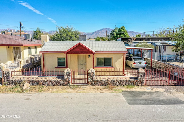 view of front facade with a carport and a mountain view