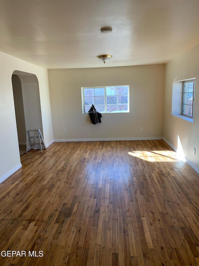 empty room with dark hardwood / wood-style flooring