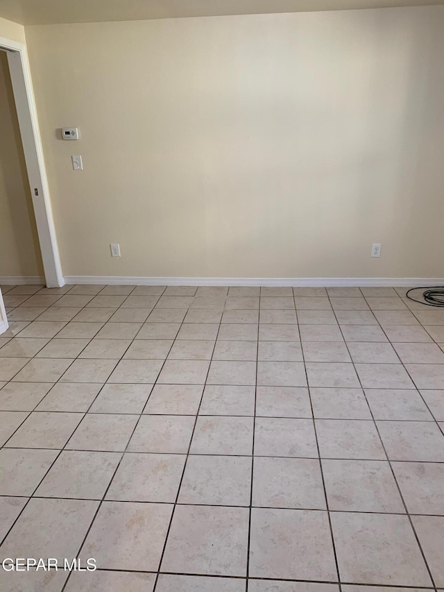 unfurnished room with light tile patterned floors