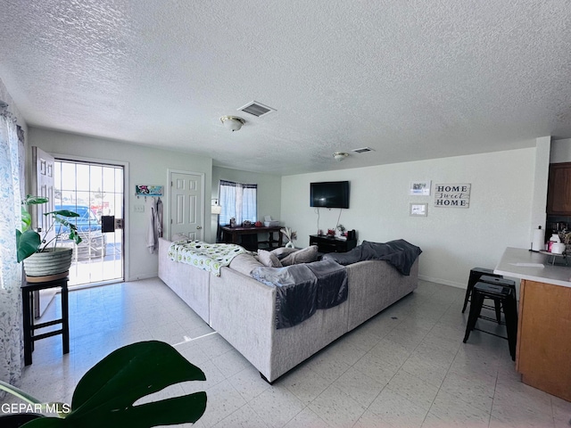 living room with a textured ceiling