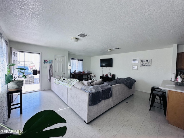 7120-7122 Second St, Canutillo, TX 79835 - living area featuring baseboards, light flooring, and a textured ceiling