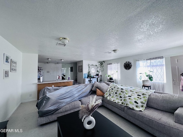 7120-7122 Second St, Canutillo, TX 79835 - living area featuring a textured ceiling and baseboards