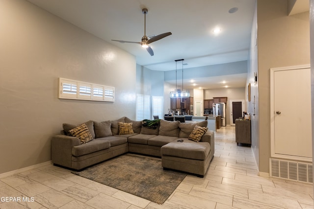 living room featuring high vaulted ceiling and ceiling fan