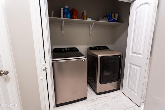 clothes washing area featuring washer and dryer