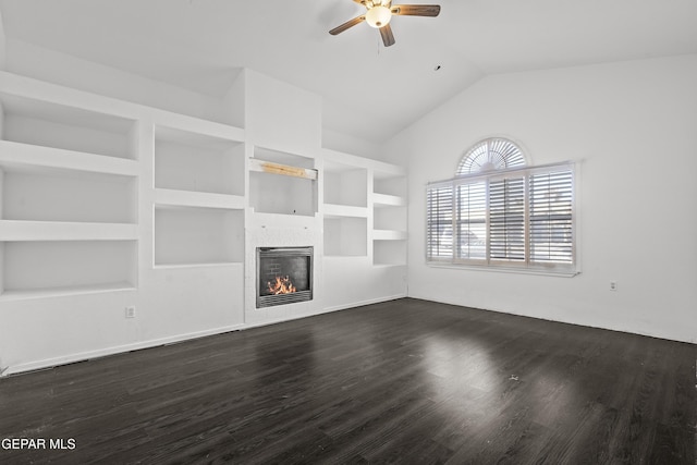 unfurnished living room featuring a tile fireplace, lofted ceiling, dark hardwood / wood-style flooring, ceiling fan, and built in shelves