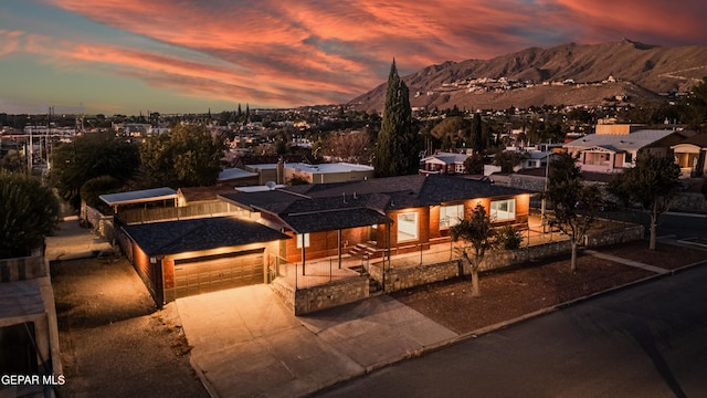 view of front facade with a mountain view and a garage