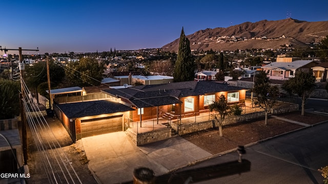 view of front of property with a mountain view and a garage