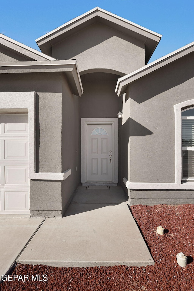 doorway to property with a garage