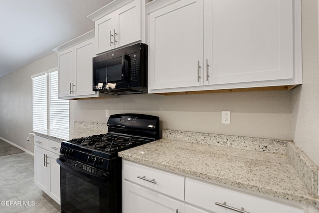 kitchen featuring black appliances, white cabinetry, and light stone countertops