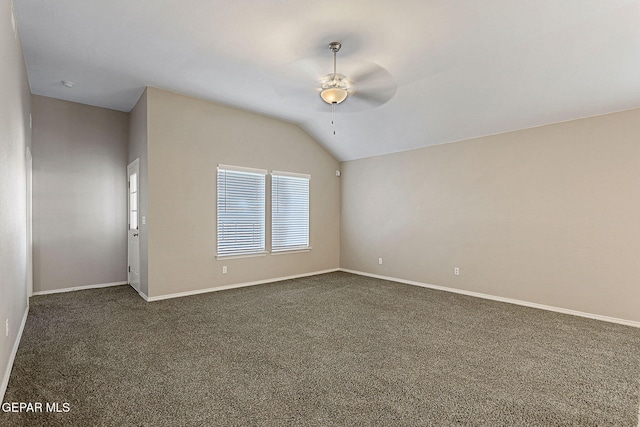 carpeted spare room with ceiling fan and lofted ceiling