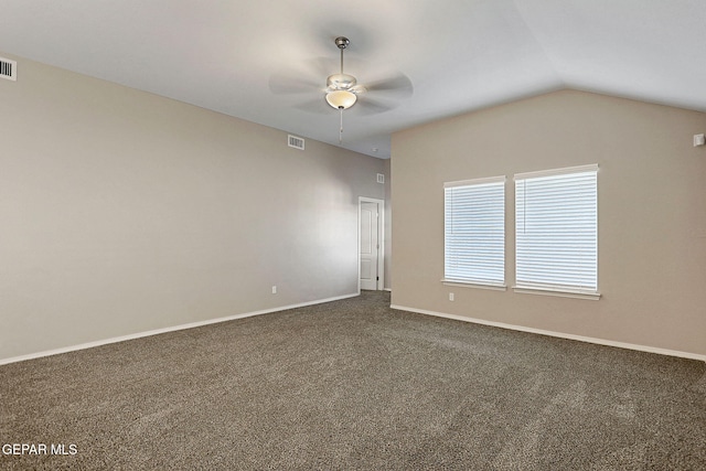 carpeted spare room featuring ceiling fan and lofted ceiling