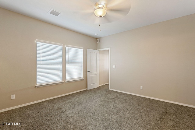 empty room featuring carpet flooring and ceiling fan