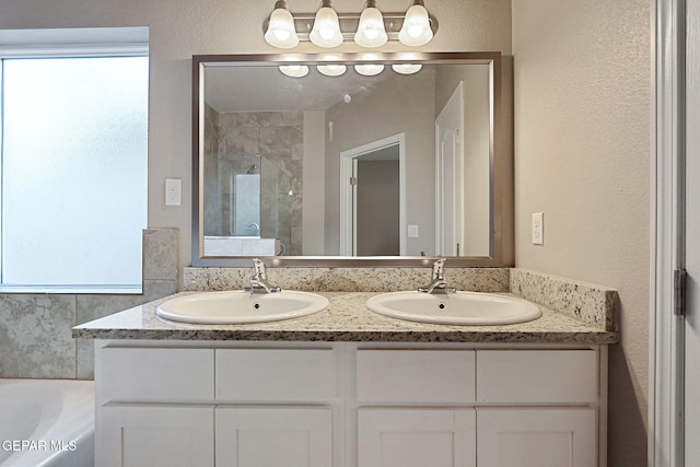 bathroom with vanity and shower with separate bathtub