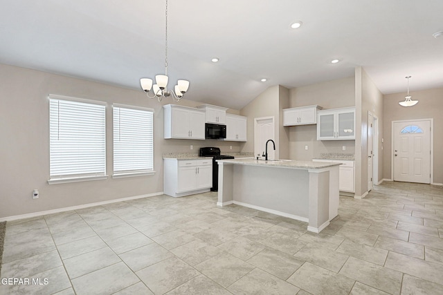 kitchen featuring sink, black appliances, decorative light fixtures, a kitchen island with sink, and white cabinets