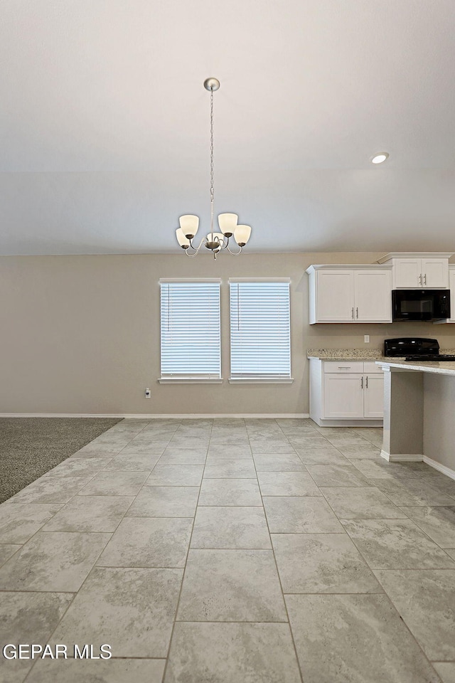 kitchen featuring black appliances, pendant lighting, a notable chandelier, and white cabinets