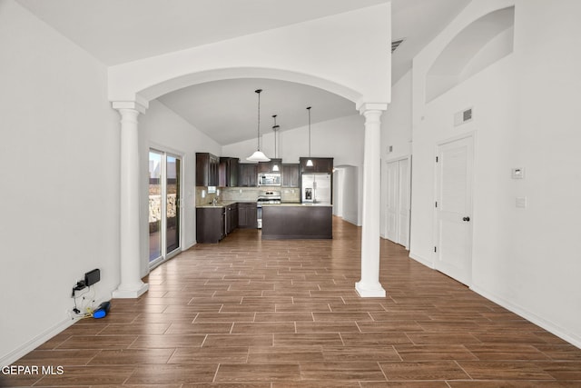 kitchen featuring dark hardwood / wood-style flooring, appliances with stainless steel finishes, and lofted ceiling