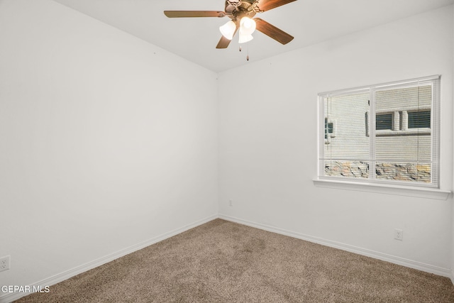 carpeted spare room with ceiling fan