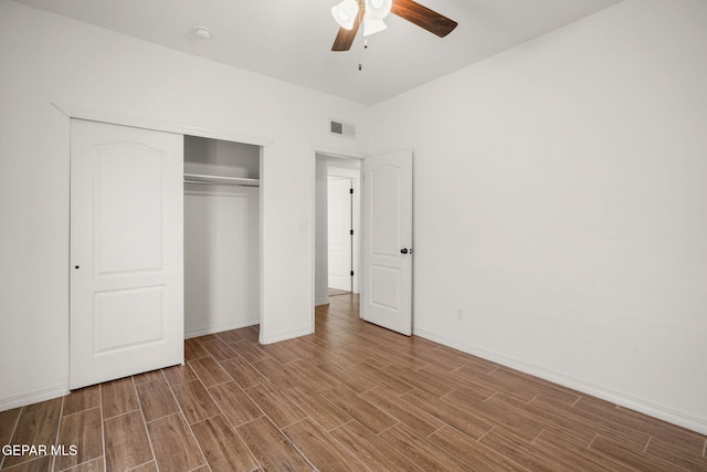 unfurnished bedroom with a closet, wood-type flooring, and ceiling fan