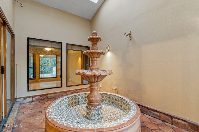 interior details featuring tile patterned flooring and a skylight