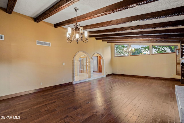 interior space with hardwood / wood-style floors, beam ceiling, a textured ceiling, and a chandelier