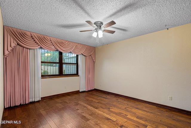 spare room featuring a textured ceiling, ceiling fan, and dark wood-type flooring