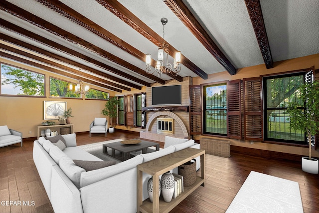 living room with vaulted ceiling with beams, a notable chandelier, a healthy amount of sunlight, and dark hardwood / wood-style flooring