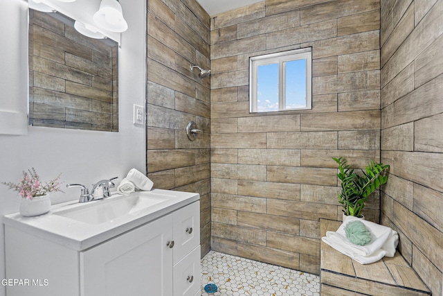 bathroom featuring vanity, tile patterned floors, and tiled shower