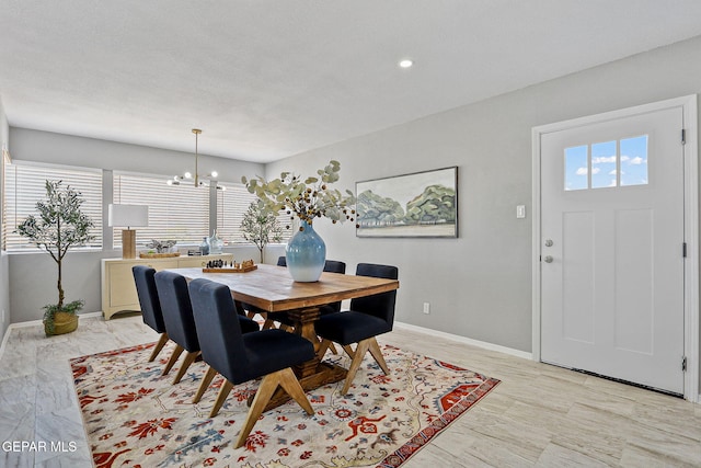 dining room with a textured ceiling and an inviting chandelier