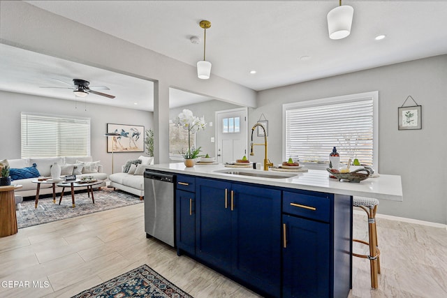 kitchen with dishwasher, blue cabinets, decorative light fixtures, and a breakfast bar area