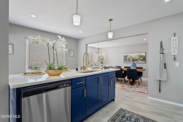 kitchen with sink, stainless steel dishwasher, blue cabinetry, light hardwood / wood-style flooring, and pendant lighting