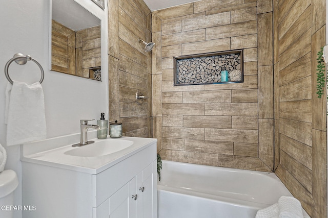 bathroom with tiled shower / bath and vanity