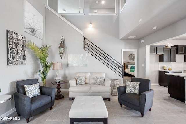 tiled living room with a towering ceiling