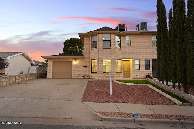 view of front facade with central AC unit and a garage