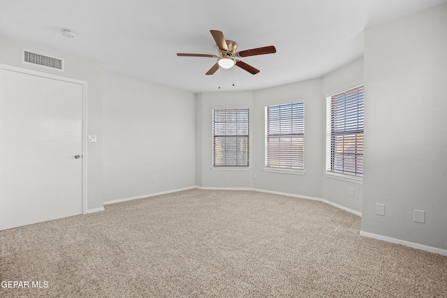 empty room with carpet flooring and ceiling fan