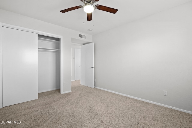 unfurnished bedroom featuring carpet, ceiling fan, and a closet