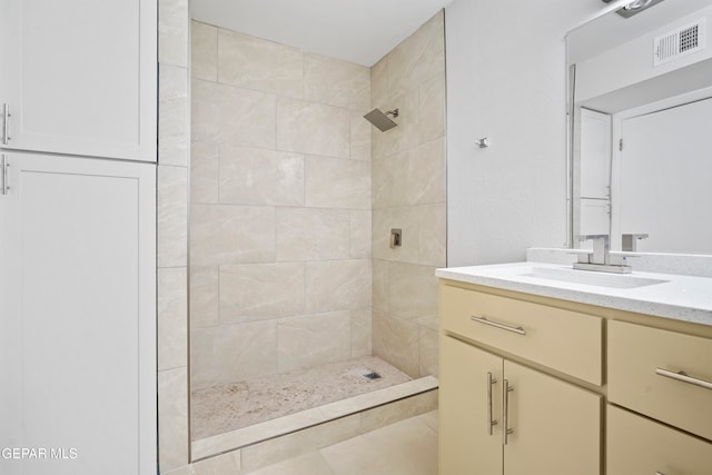 bathroom featuring vanity and a tile shower