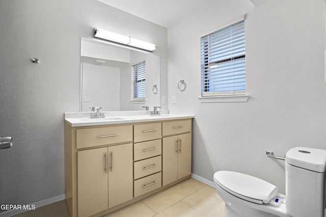 bathroom featuring tile patterned flooring, vanity, and toilet