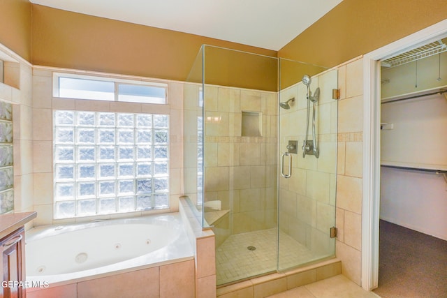 bathroom featuring a wealth of natural light, vanity, and independent shower and bath