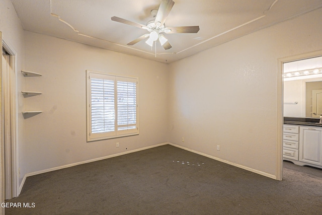 unfurnished bedroom with ceiling fan and dark carpet