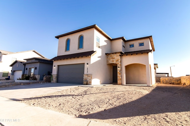 mediterranean / spanish house with a garage