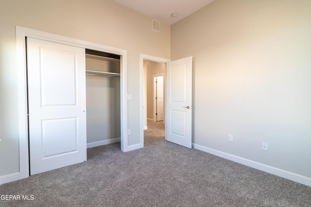 unfurnished bedroom featuring carpet floors and a closet