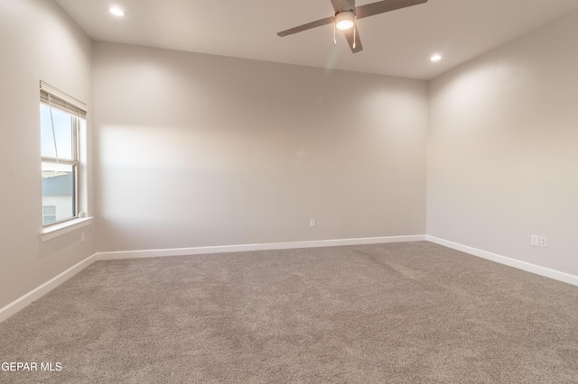 carpeted spare room featuring ceiling fan