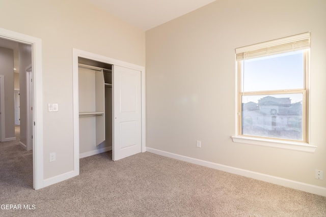 unfurnished bedroom with carpet flooring and a closet