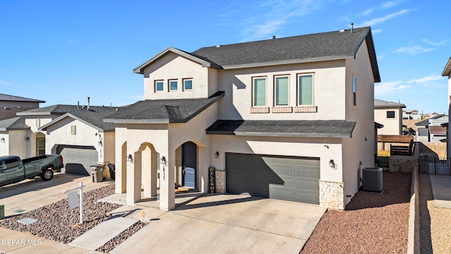 view of front of property with a garage and cooling unit