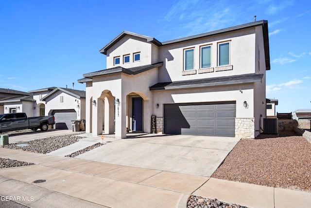 view of front of home featuring central AC unit and a garage