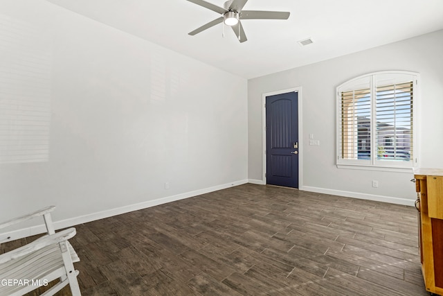 spare room featuring dark wood-type flooring and ceiling fan