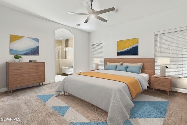 carpeted bedroom featuring ensuite bathroom and ceiling fan